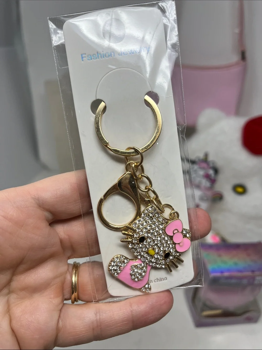HELLO KITTY BUNDLE 7 -BEANIE, 2 KEYCHAIN, CRÈME SHOP BATH BOMB LIP BALM, CHARM